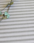 leaves on a grey ticking stripe oilcloth