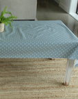blue dotty oilcloth on a wooden table