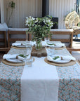 Dining table set with floral centerpiece on a patio