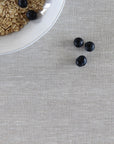 Oatmeal with blueberries on a beige linen tablecloth