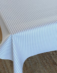 Ticking stripe oilcloth on a wooden table.
