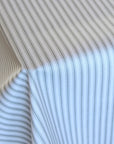 Close-up of a tablecloth with thin blue stripes on a plain background
