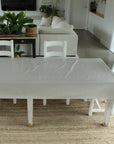 Dining table with white tablecloth in a living room setting