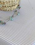 Small green plant on a tablecloth with a woven basket in the corner