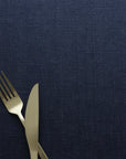 Gold fork and knife on a navy blue tablecloth
