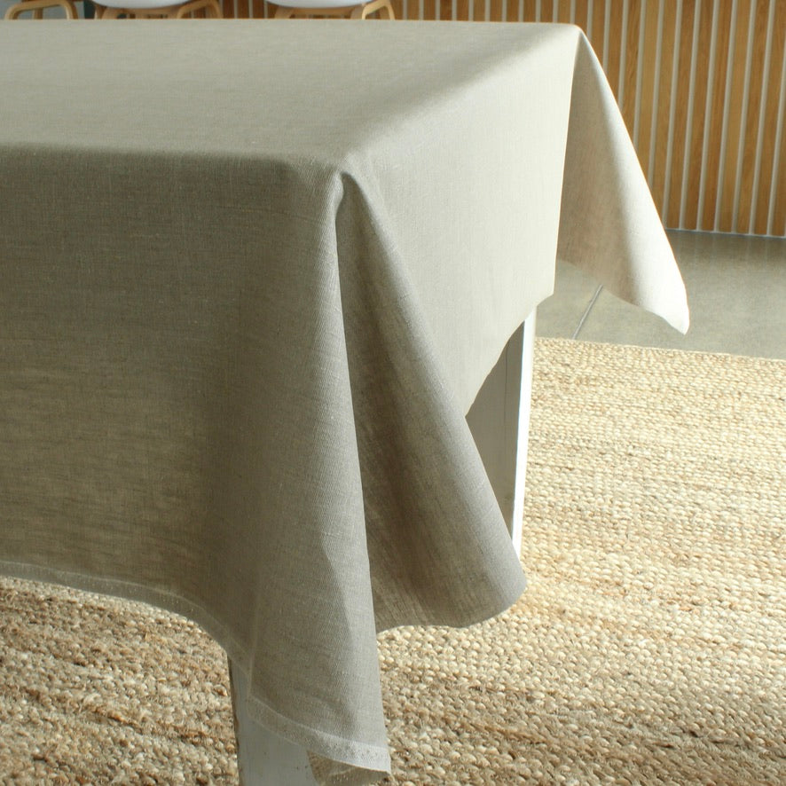 Beige tablecloth on a table in a room with wooden flooring