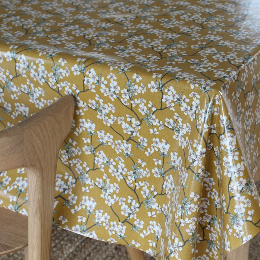 Yellow floral patterned tablecloth on a wooden chair
