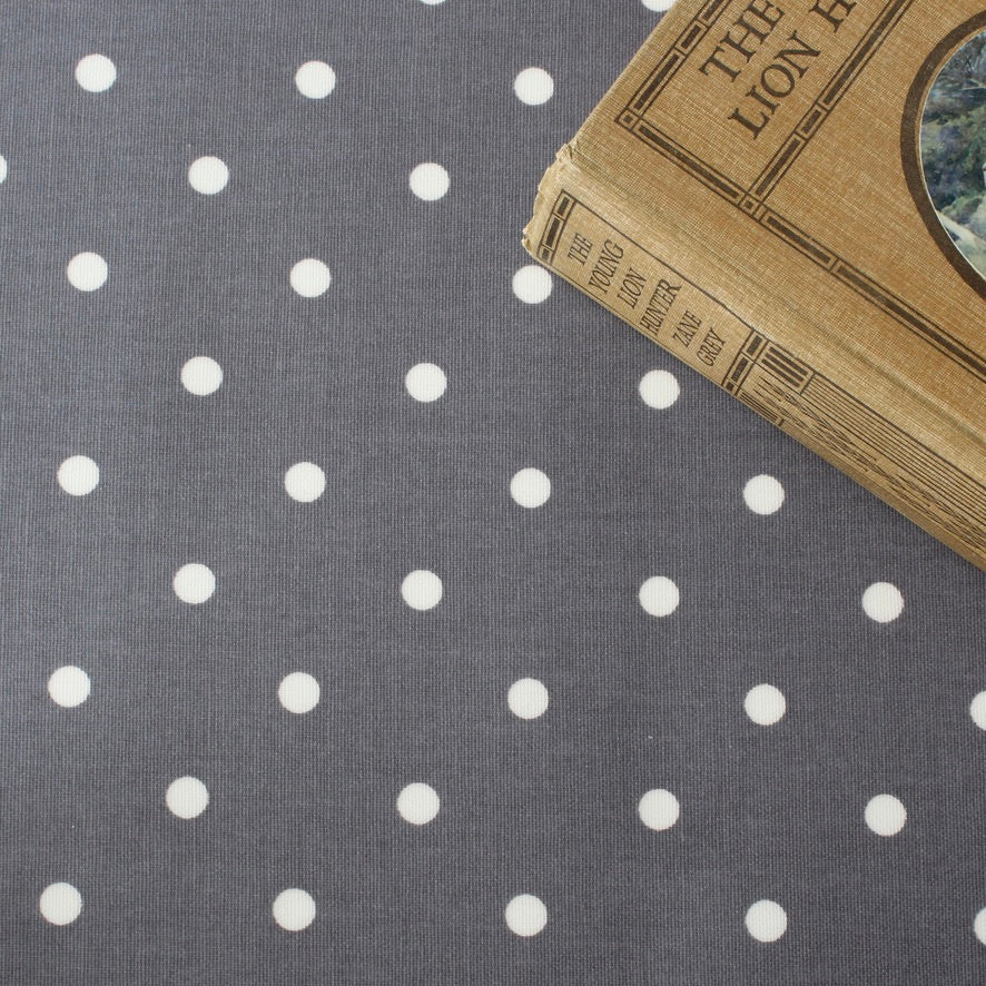 Vintage book on a gray oilcloth with white polka dots