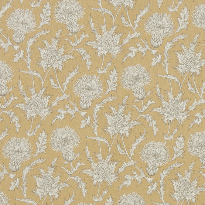 Thistle pattern with white flowers on a yellow tablecloth