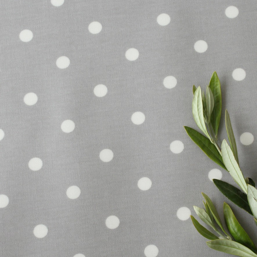 Gray oilcloth with white polka dots and green leaves on the right side