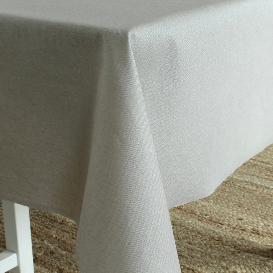 Gray tablecloth draped over a table with a textured surface.