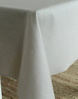 Gray tablecloth draped over a table with a textured surface.