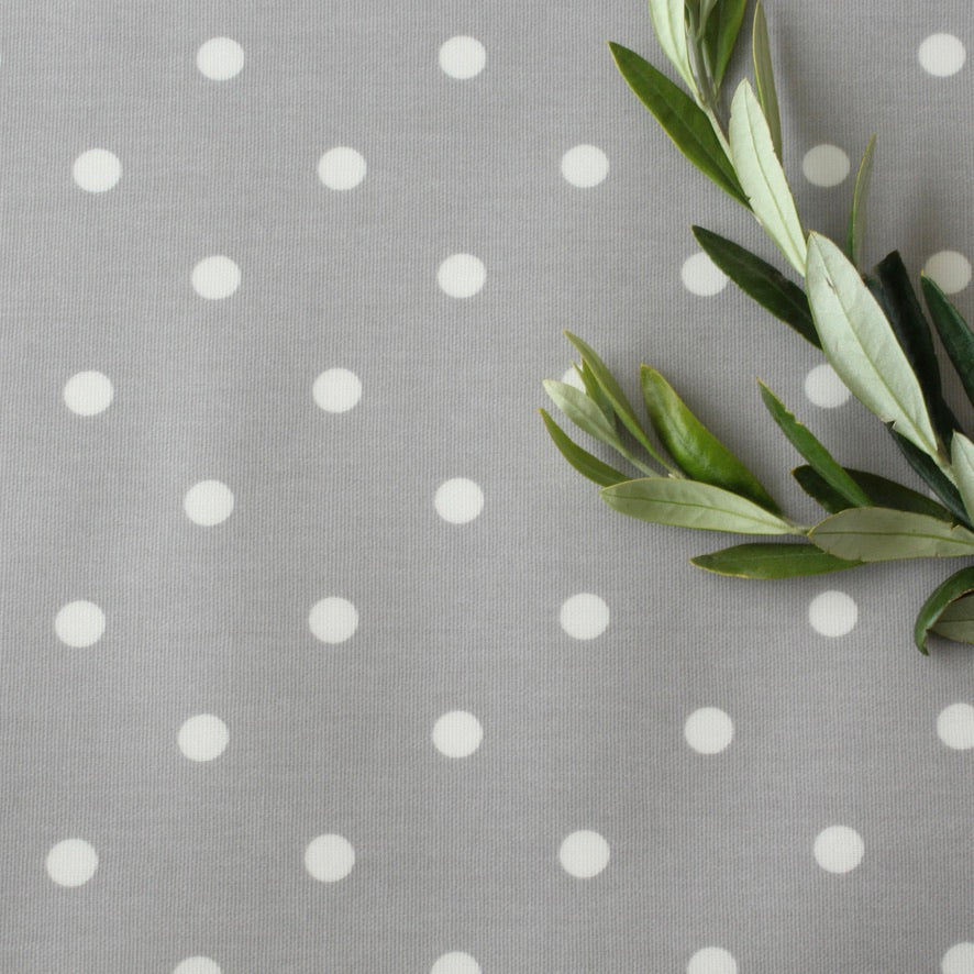 Gray oilcloth with white polka dots and green leaves on the right side