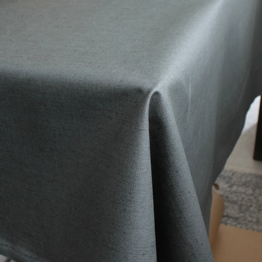 Gray green tablecloth draped over a table