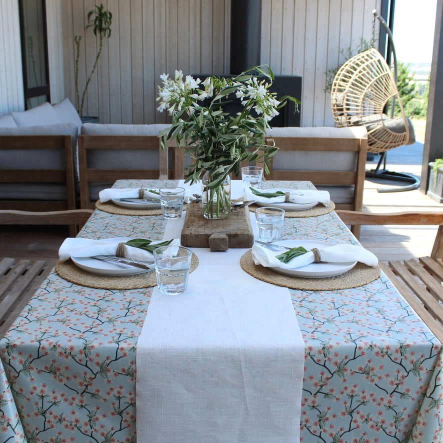 Dining table set with floral centerpiece on a patio