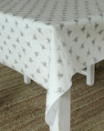 White tablecloth with gray bee pattern on a white table