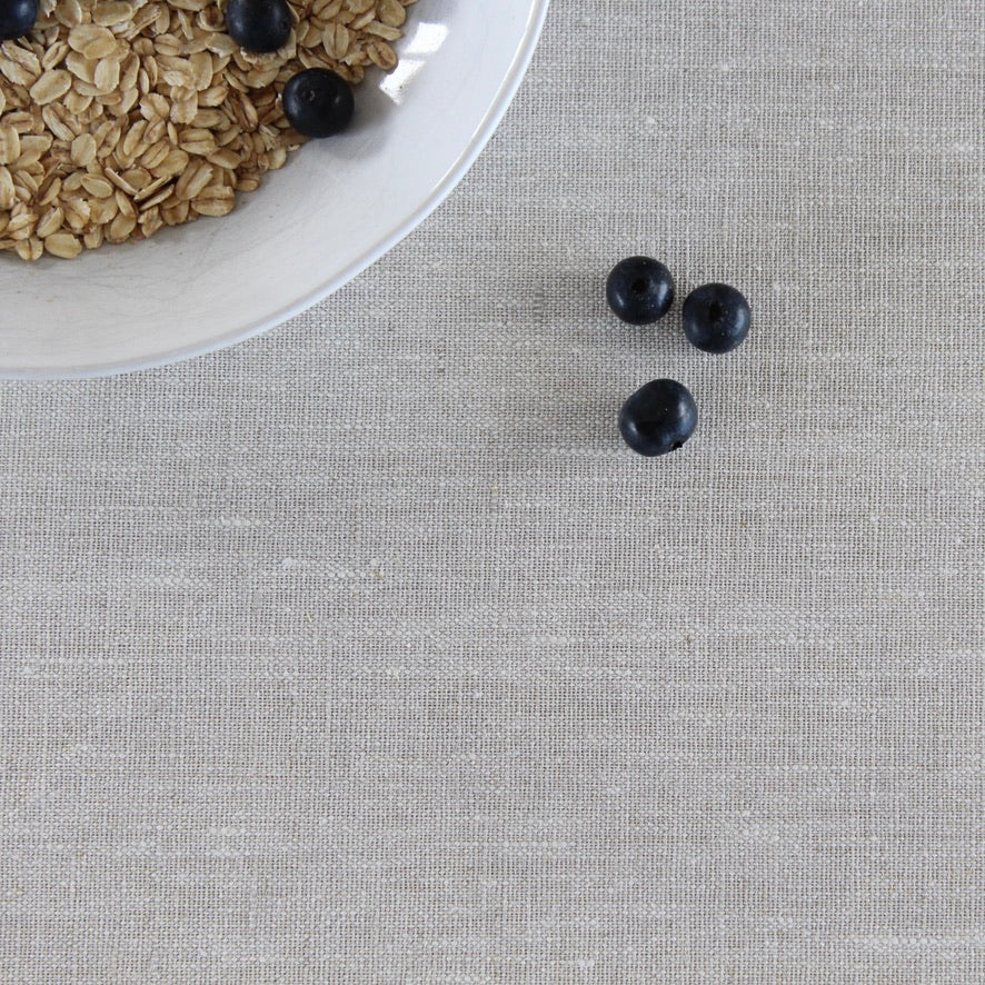 Oatmeal with blueberries on a beige linen tablecloth