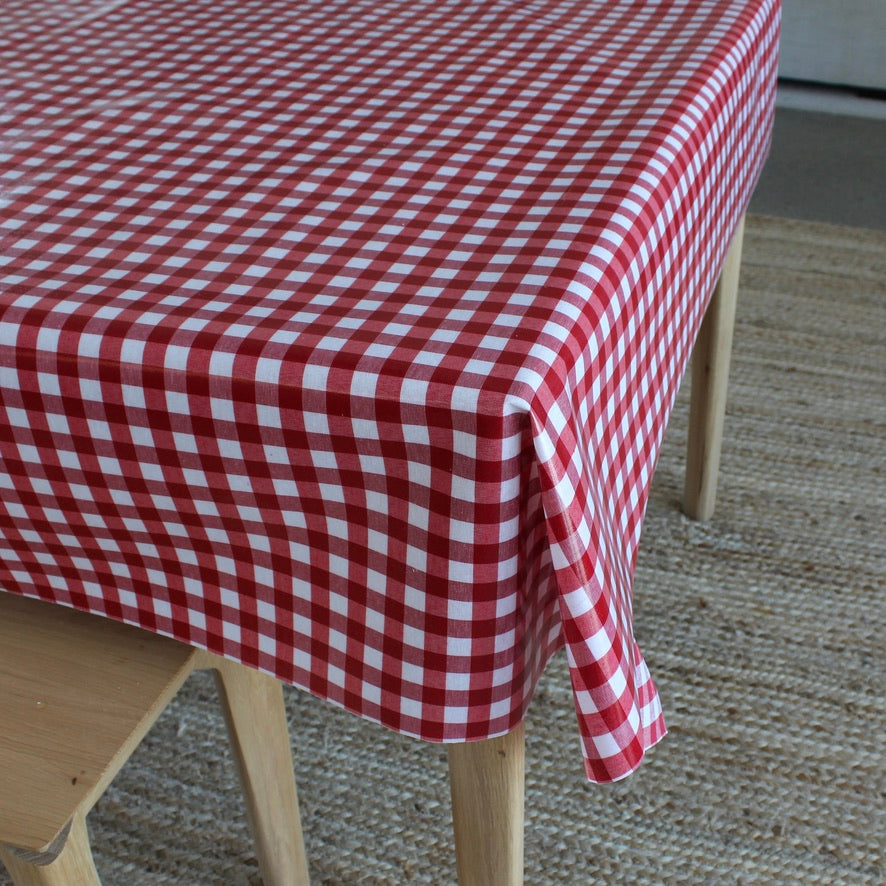 Red and white checkered tablecloth on a wooden table.