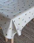 Tablecloth with bee pattern on a wooden table
