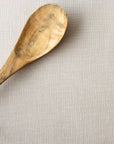 Wooden spoon on a beige linen tablecloth