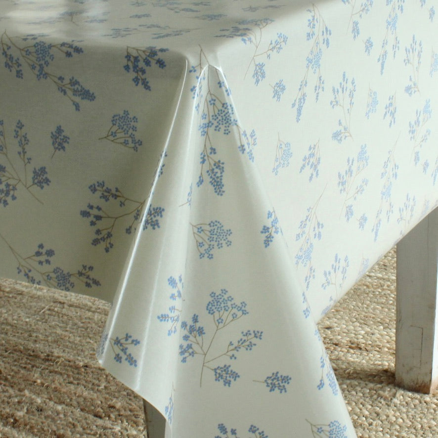 Floral-patterned tablecloth on a table with a textured surface