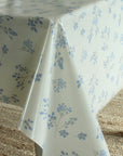Floral-patterned tablecloth on a table with a textured surface