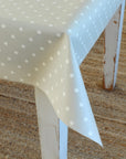 White chair with a polka dot tablecloth on a textured surface