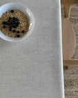 Bowl of granola with blueberries on a beige linen tablecloth
