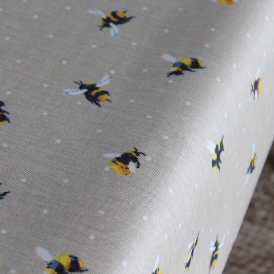 Oilcloth with bee pattern on a beige background