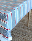 Striped tablecloth with red, white, and blue pattern on a wooden table.