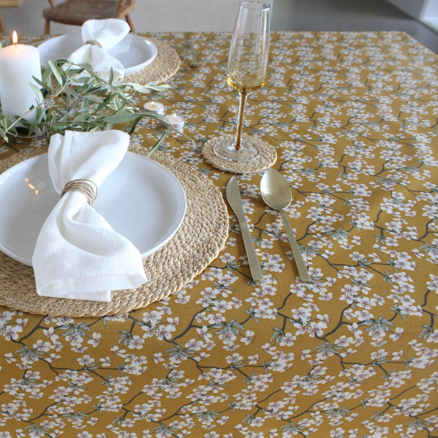 yellow floral oilcloth with linen napkin table setting