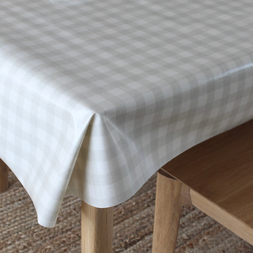 Checkered tablecloth on a wooden table with a chair