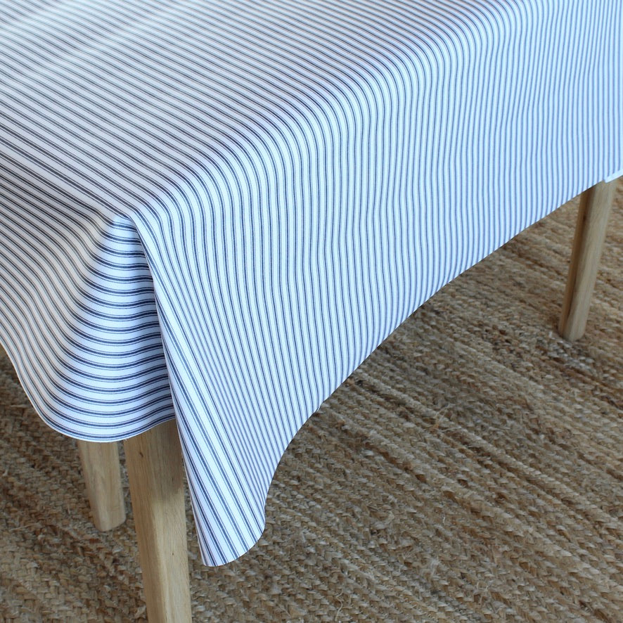 Striped tablecloth on a wooden table with a textured surface