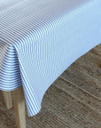 Striped tablecloth on a wooden table with a textured surface