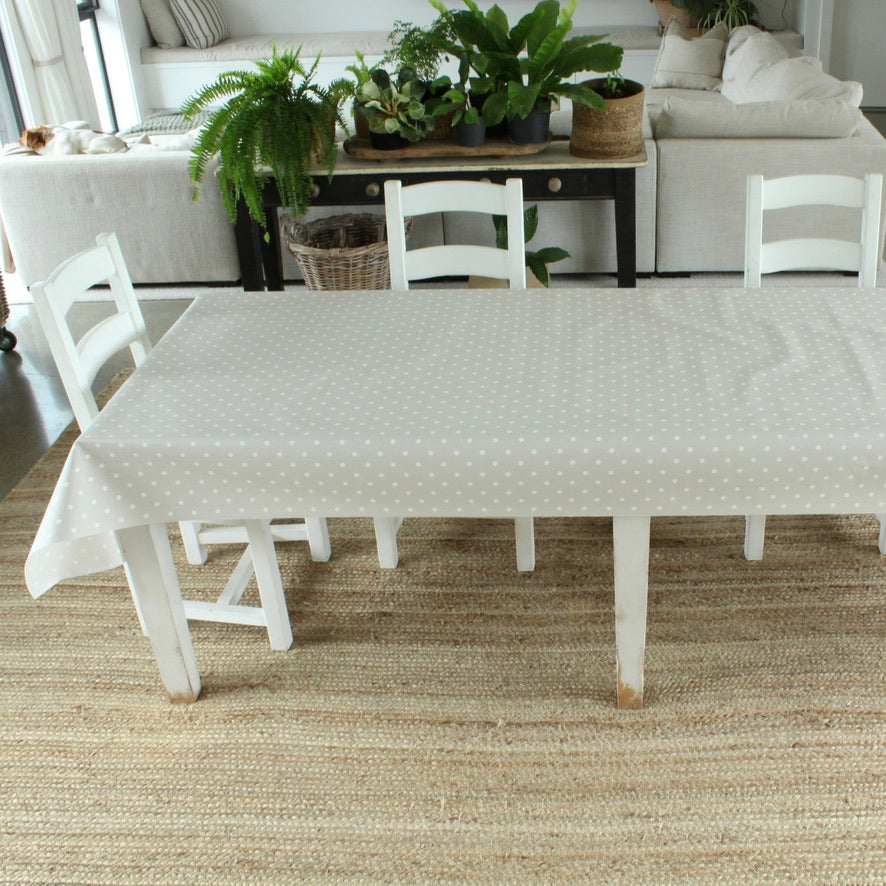 White table with a dotty patterned oilcloth in a living room setting