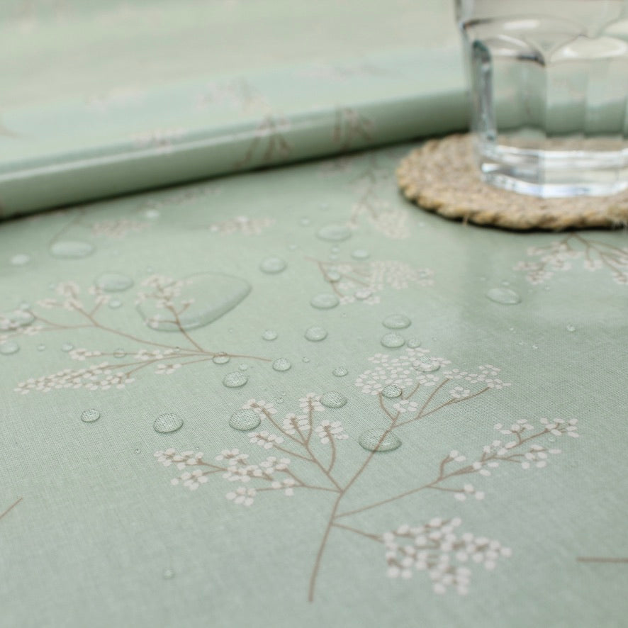 Light green tablecloth with floral patterns on a table