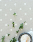 Rosemary leaves on a polka dot oilcloth background