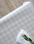 Checkered gingham oilcloth with white linen napkin