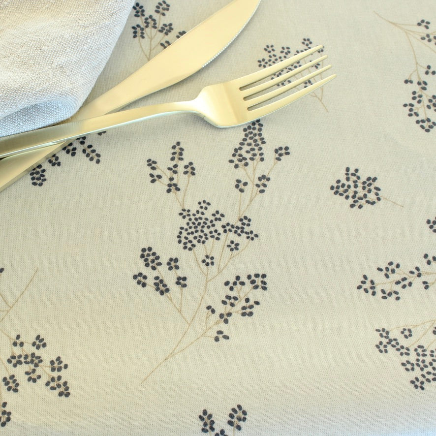 Knife and fork on a decorative tablecloth with floral patterns