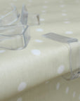 Clear plastic tablecloth clips on a polka dot fabric surface