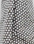 Close-up of an oilcloth with a black and white polka dot pattern.
