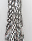 Black and white polka dot oilcloth on a white background
