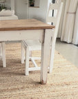 white wipeable linen tablecloth being put on a wooden table