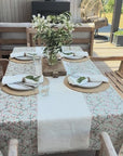 blue floral tablecloth in an outdoor dining area with a white table runner