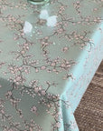 video of a floral oilcloth with ice cubes being wiped off it