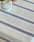 video of water being spilled onto a wipe clean striped tablecloth