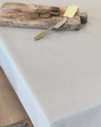 grey striped tablecloth oilcloth with a rustic cheese board