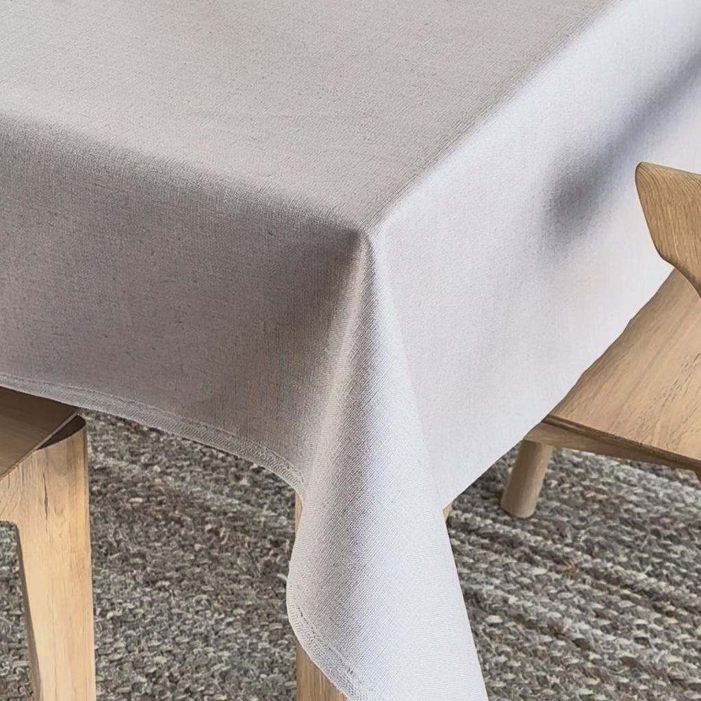 Beige coloured wipeable linen tablecloth on a wooden table