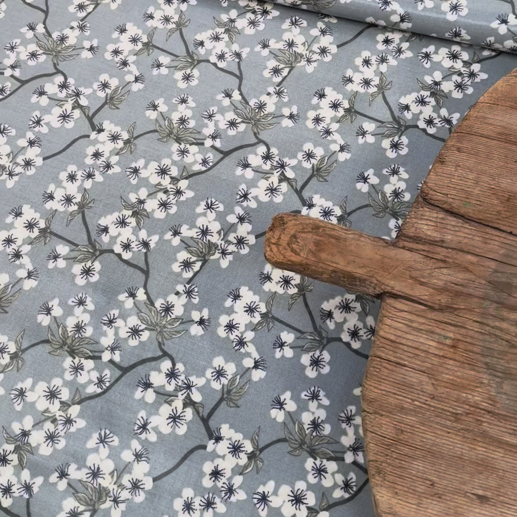 Blue and white floral pattern oilcloth with a wooden board