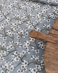 Blue and white floral pattern oilcloth with a wooden board